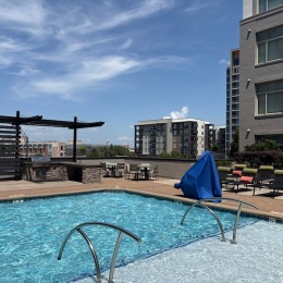 a swimming pool with lounge chairs
