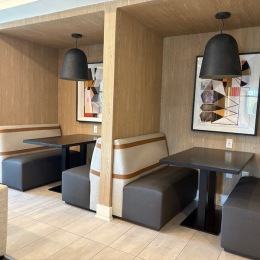 a clubroom with tables and booths