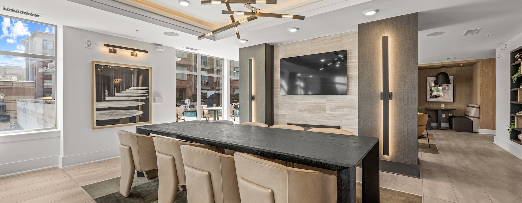 a room with a tv, table and chairs