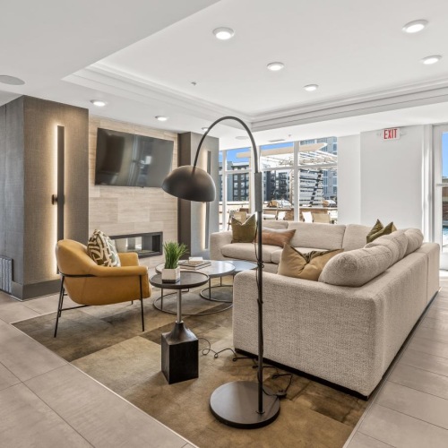 a clubroom with couches, tables and a tv